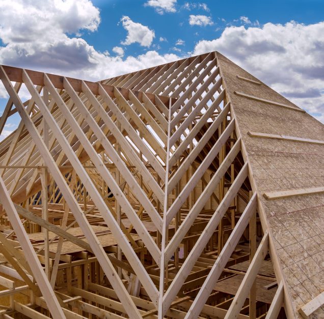 Panorama top view of closeup new wooden roof beams built home under construction under framing with construction site